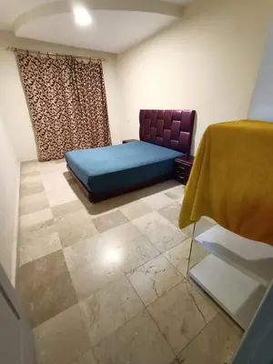 a bedroom with a blue bed in a room at Family apartment 22 in Marrakech