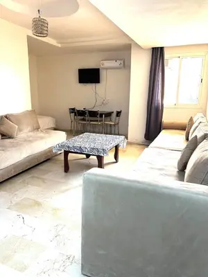 a living room with a couch and a table at Family apartment 10 in Marrakech