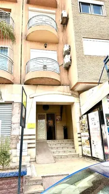 a building with stairs and a balcony on it at Family apartment 10 in Marrakech