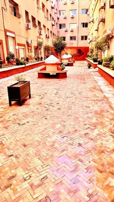 a courtyard with benches and tables in a building at Family apartment 10 in Marrakech