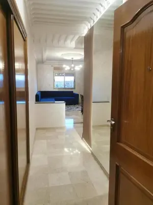 a hallway with a door and a room with a couch at 2-bedroom luxury contemporary apartment Hivernage in Marrakech