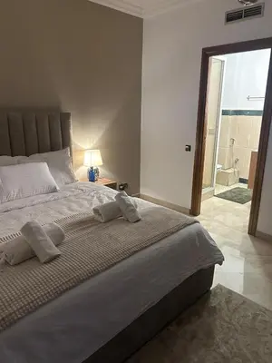 a bedroom with a large bed with a view of the ocean at 2-bedroom luxury contemporary apartment Hivernage in Marrakech