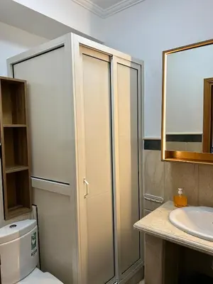 a bathroom with a shower and a toilet and a sink at 2-bedroom luxury contemporary apartment Hivernage in Marrakech