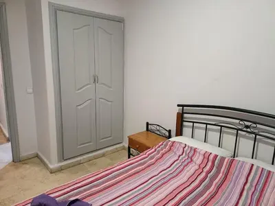 a bedroom with a bed and a closet at 30 family apartment in Marrakech