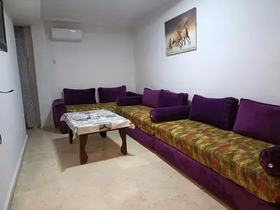 a living room with a couch and a table at 30 family apartment in Marrakech