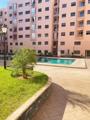 a building with a swimming pool in front of a building at Appartement cosy à Marrakech in Marrakech