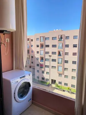 a washing machine in front of a window with a building at Appartement cosy à Marrakech in Marrakech