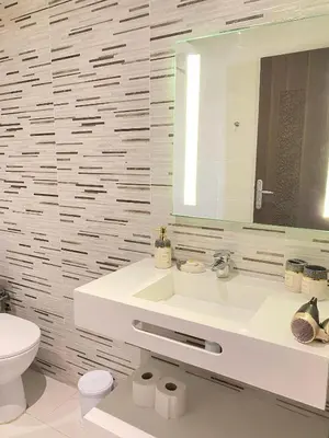 a bathroom with a sink and a toilet and a mirror at Appartement cosy à Marrakech in Marrakech