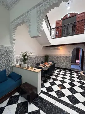 a restaurant with a black and white checkered floor at Riad abdel in Marrakech