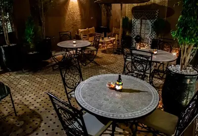 a table with a bottle of beer on top of it at RIAD Dar ZOMOROD in Marrakech