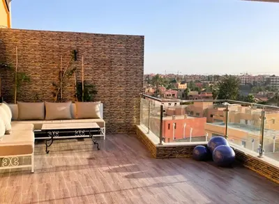 a balcony with a couch and a view of a city at Appartement 1 chambre - Superbe Terrasse & Vue Panoramique - Semlalia in Marrakech
