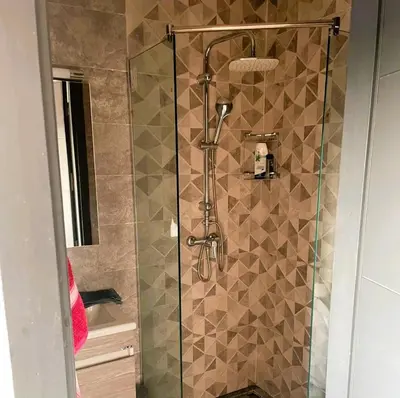 a shower with a glass door in a bathroom at Appartement 1 chambre - Superbe Terrasse & Vue Panoramique - Semlalia in Marrakech
