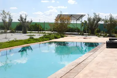 a large swimming pool with a gazebo at Villa avec piscine privée et sans vis à vis à Marrakech in Douar Nouaji