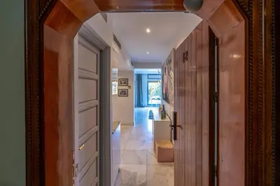 a hallway with a door leading to a hallway with a staircase at Luxury Oasis 2 Bedroom and Free Parking in Hivernage in Marrakech