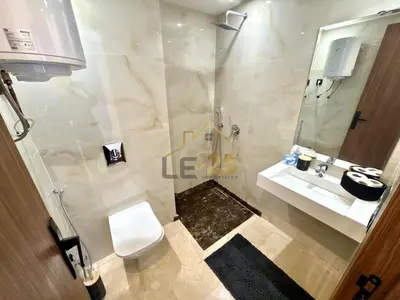 a bathroom with a toilet and a sink and a mirror at Appartement 2 chambres Résidence Atlassi derrière Carré Eden en plein coeur de Gueliz in Marrakech