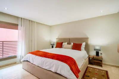 a bedroom with a large bed and a window at Stayin 3Bedroom Duplex in Marrakech