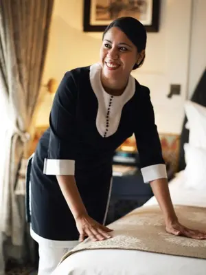 a woman standing on top of a bed at A Stay To Remember - Marrakech Downtown in Marrakech