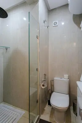 a bathroom with a toilet and a glass shower at A Stay To Remember - Marrakech Downtown in Marrakech