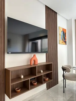 a living room with a television on a wall at Appart haut standing - centre ville in Marrakech