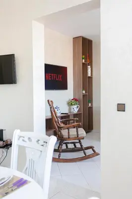 a living room with a chair and a tv at Spacious Family Flat in Marrakech