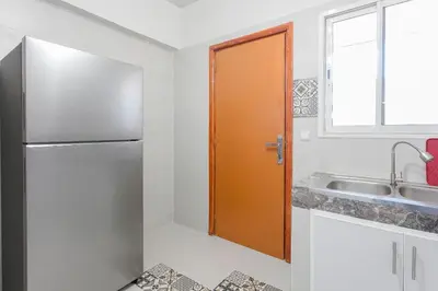 a kitchen with a refrigerator and a sink at Spacious Family Flat in Marrakech