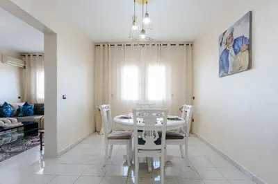 a dining room with a table and chairs at Spacious Family Flat in Marrakech