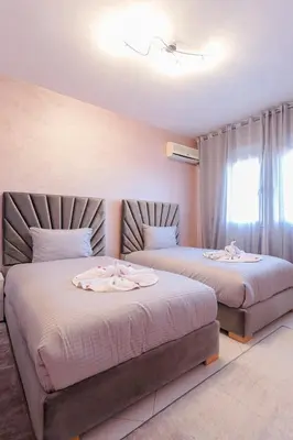a bedroom with two beds and a window at Spacious Family Flat in Marrakech
