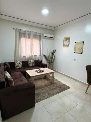 a living room with a couch and a table at Beautiful Luxurious 2-bedroom with Wi-Fi Gueliz, Marrakech in Marrakech