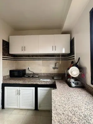 a kitchen with white cabinets and a counter top at Beautiful Luxurious 2-bedroom with Wi-Fi Gueliz, Marrakech in Marrakech