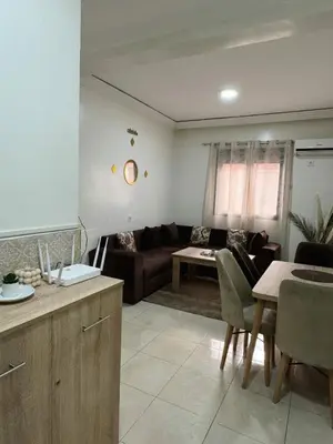 a living room with a couch and a table at Beautiful Luxurious 2-bedroom with Wi-Fi Gueliz, Marrakech in Marrakech