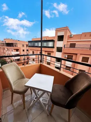 two chairs and a table on a balcony at Beautiful Luxurious 2-bedroom with Wi-Fi Gueliz, Marrakech in Marrakech