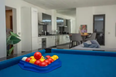 a pool table with a tray of balls on it at Atlas Twin in Marrakech