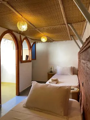 a bedroom with a bed and a table in it at Riad Numidia in Marrakech