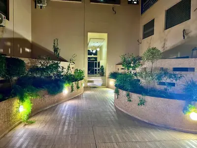 a courtyard with plants and lights in a building at Appartement à louer in Marrakech