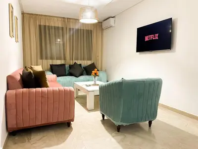 a living room with two chairs and a couch at Appartement à louer in Marrakech