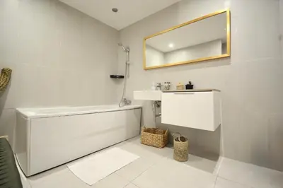 a bathroom with a white tub and a mirror at M17-Le Duplex-Balcon-Piscine-Majorelle in Marrakech