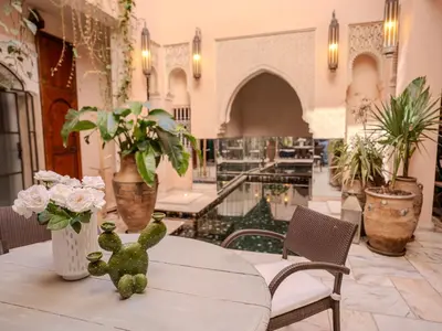 a table with a teddy bear sitting on top of it at Riad MAYAN Heated Pool and GYM in Marrakech