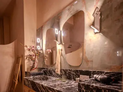 a bathroom with two sinks and two mirrors at Riad MAYAN Heated Pool and GYM in Marrakech