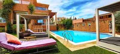 a swimming pool in the backyard of a house at Amlkis golf royal in Marrakech