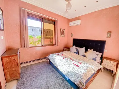 a bedroom with a large bed and a window at Amlkis golf royal in Marrakech