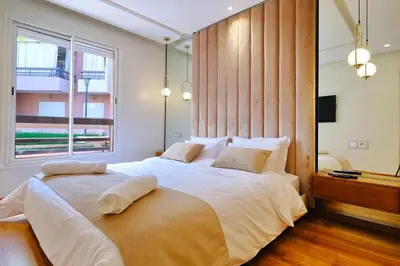a bedroom with a large bed with a large window at Awesome Luxury Apartment in Marrakech in Marrakech