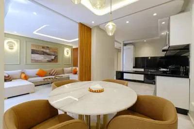a living room with a table and chairs and a couch at Awesome Luxury Apartment in Marrakech in Marrakech