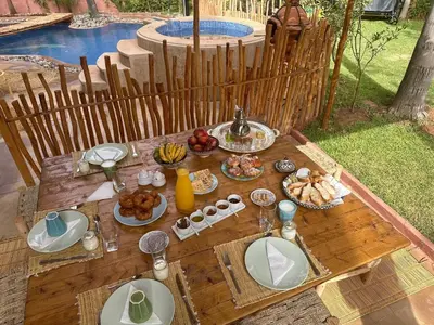 a wooden table with food on top of it at Villa Riad Jawhar & SPA in Marrakech