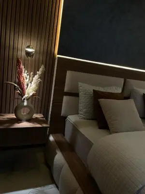 a bedroom with a bed and a vase with flowers at Modern Apartment Airport in Marrakech