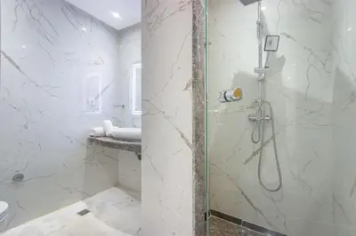 a bathroom with a shower with a glass door at NEW! appt au cœur de Gueliz ,Terrasse,IPTV,parking in Marrakech