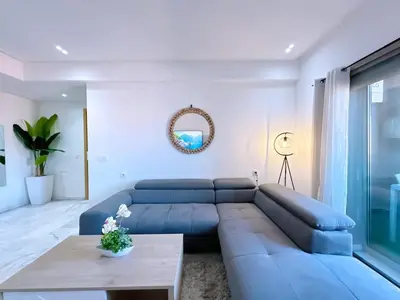a living room with a blue couch and a table at NEW! appt au cœur de Gueliz ,Terrasse,IPTV,parking in Marrakech