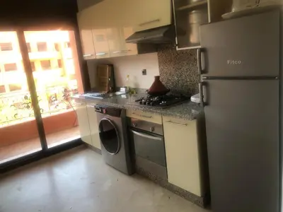 a kitchen with a refrigerator and a washer and dryer at - Résidence Babylone Y - 1 Bedroom Appartement in Marrakech