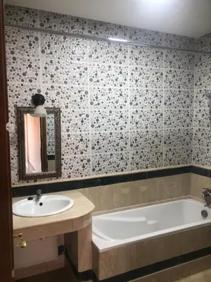 a bathroom with a tub and a sink and a bath tub at - Résidence Babylone Y - 1 Bedroom Appartement in Marrakech
