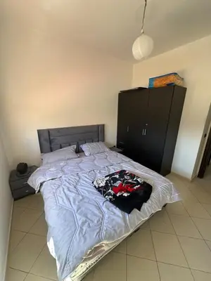 a bedroom with a large bed with a blue comforter at Sharing Apartment Standard Room in Marrakech