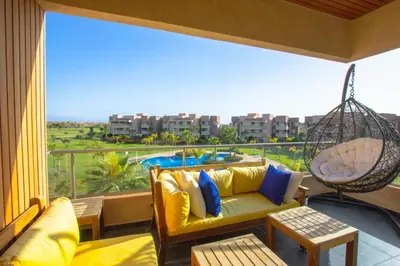 a balcony with a couch and a swing at Appartement 3 Chambres in Marrakech